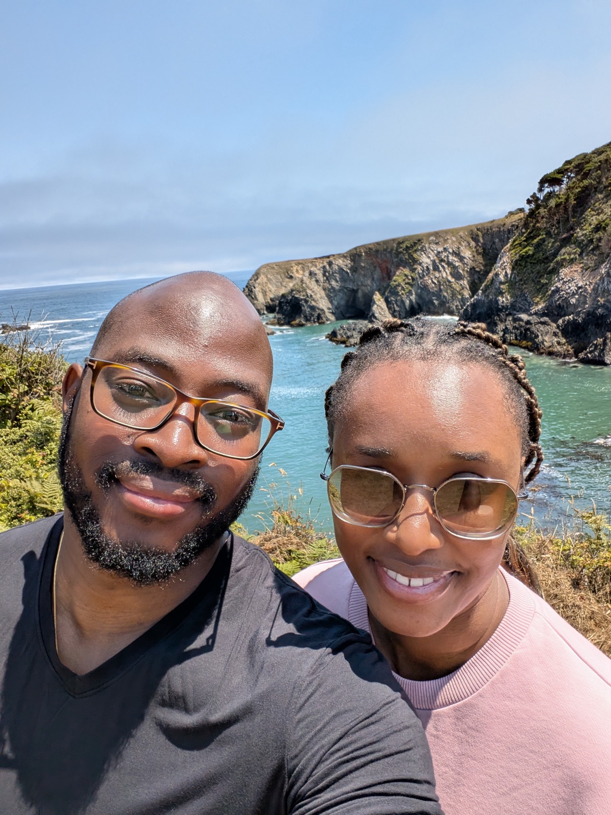 Sally and Adetunji above a cove on the California coast, July 2025